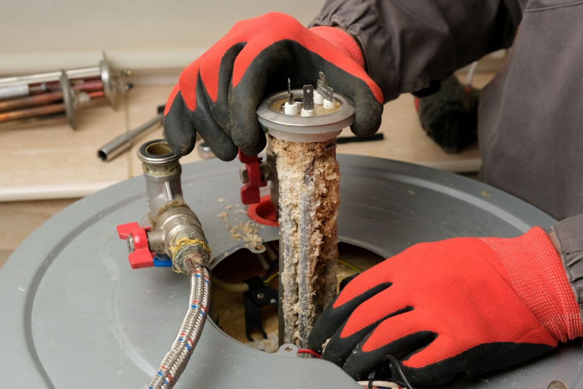 A repairman working on a boiler.