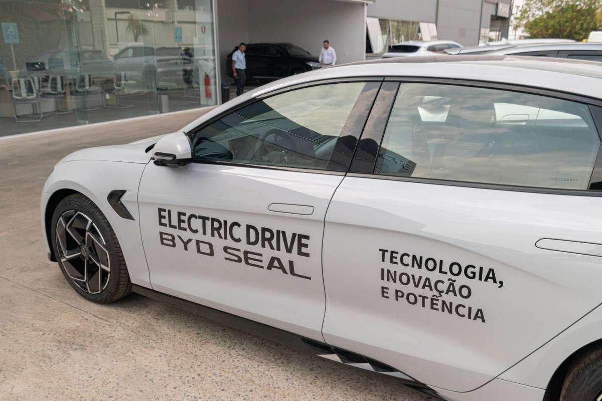 A white electric car with "Electric Drive BYD Seal" and additional text displayed on the side.