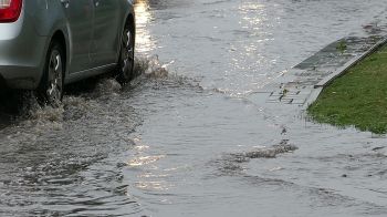A car driving on a flooded street.
