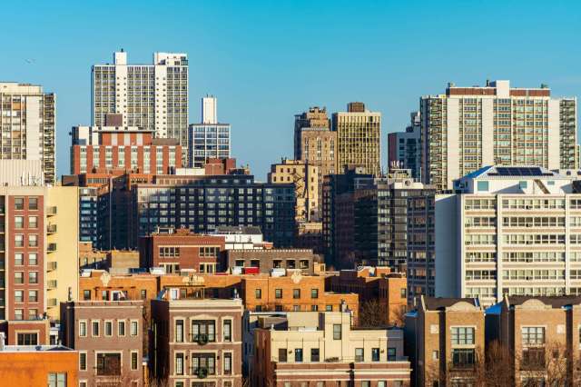 A skyline view featuring a mix of modern high-rises and older buildings.