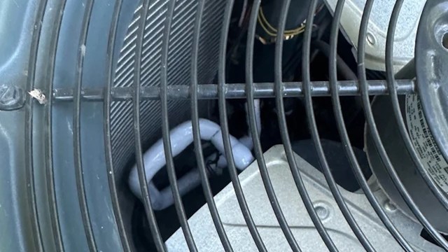A protective grate on an AC unit.