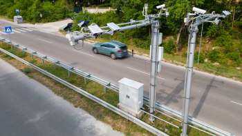 Traffic surveillance cameras on metal poles.