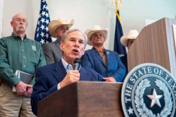 Texas Gov. Greg Abbott speaking at a podium.