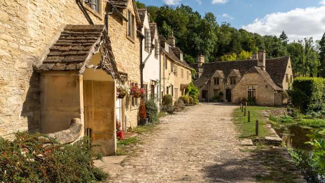A cobblestone pathway lined with cottages.