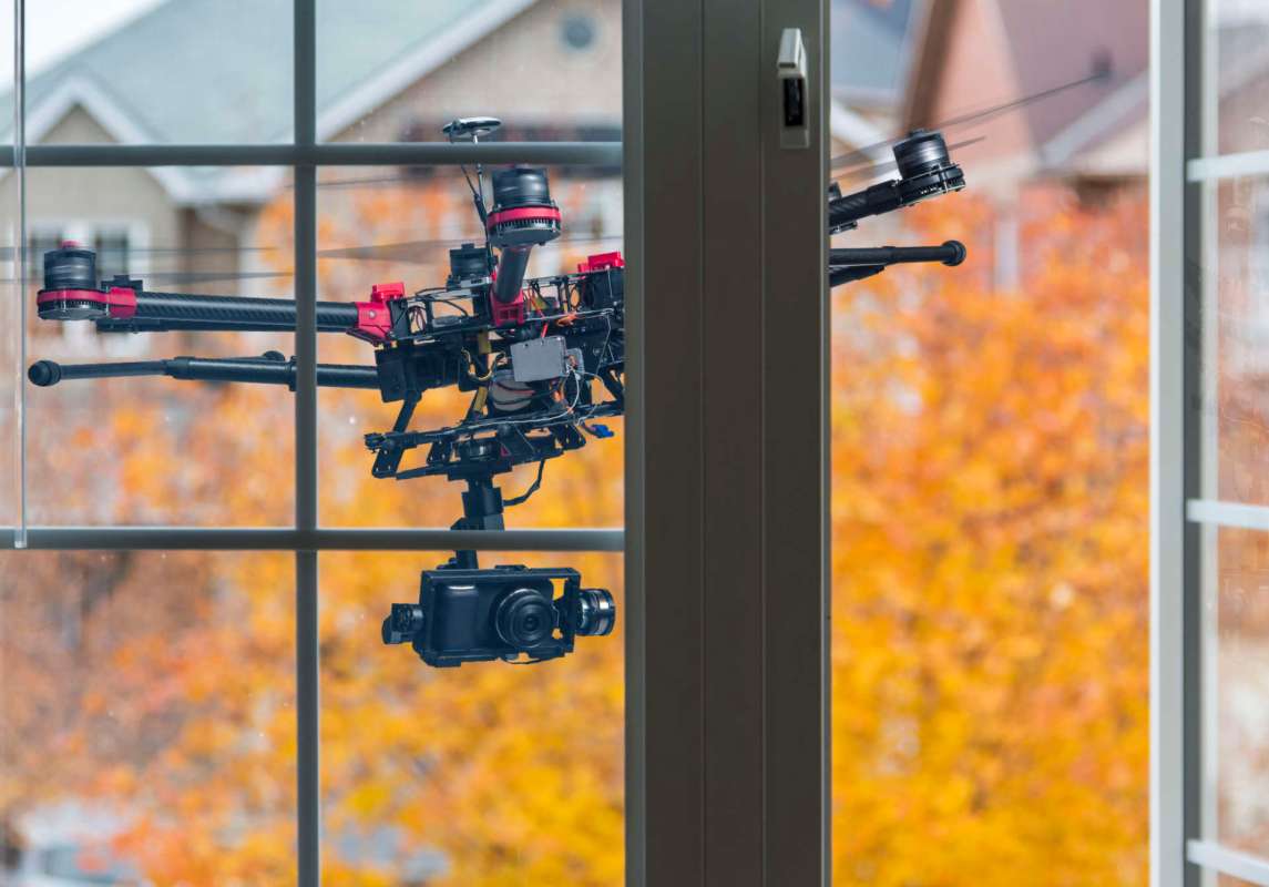A drone outside a window.