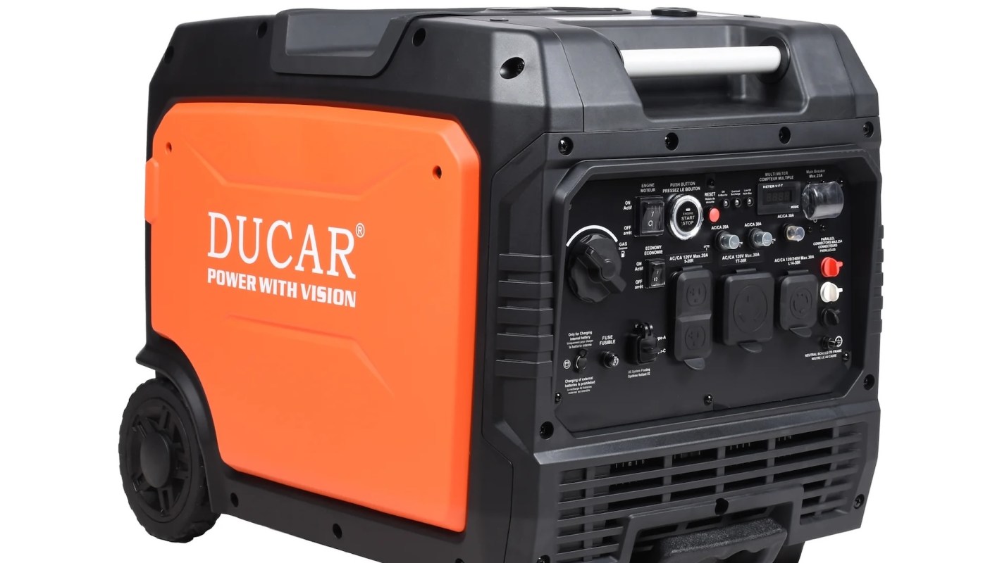 A portable Ducar generator with an orange and black exterior and various controls and outlets.