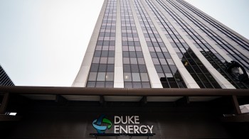 A tall office building with a sign for Duke Energy at the entrance.