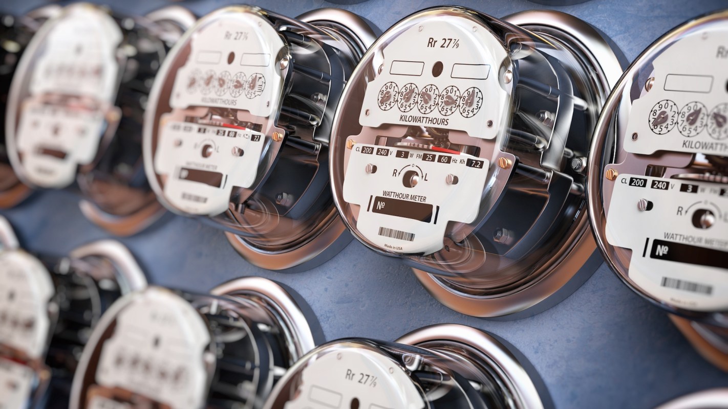 A row of electrical meters mounted on a wall.