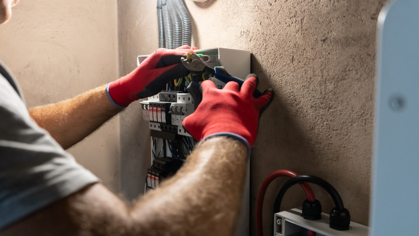 A person working on a circuit breaker.