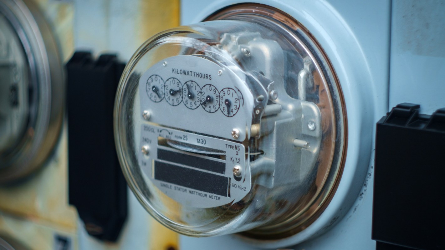 A close-up image of an electric meter displaying kilowatt-hour readings.
