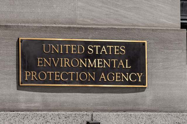 A plaque displaying the text "United States Environmental Protection Agency" mounted on a stone wall.