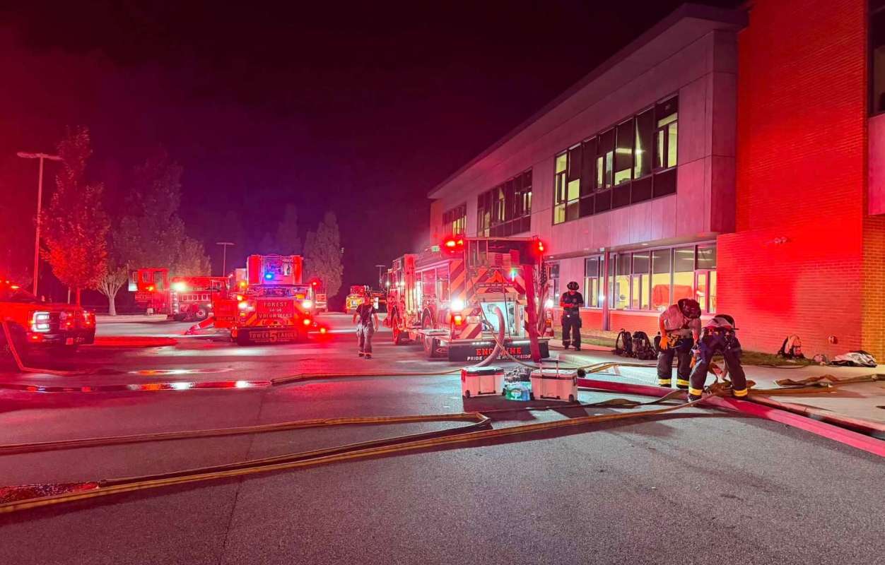 Firefighters and fire trucks at a school.