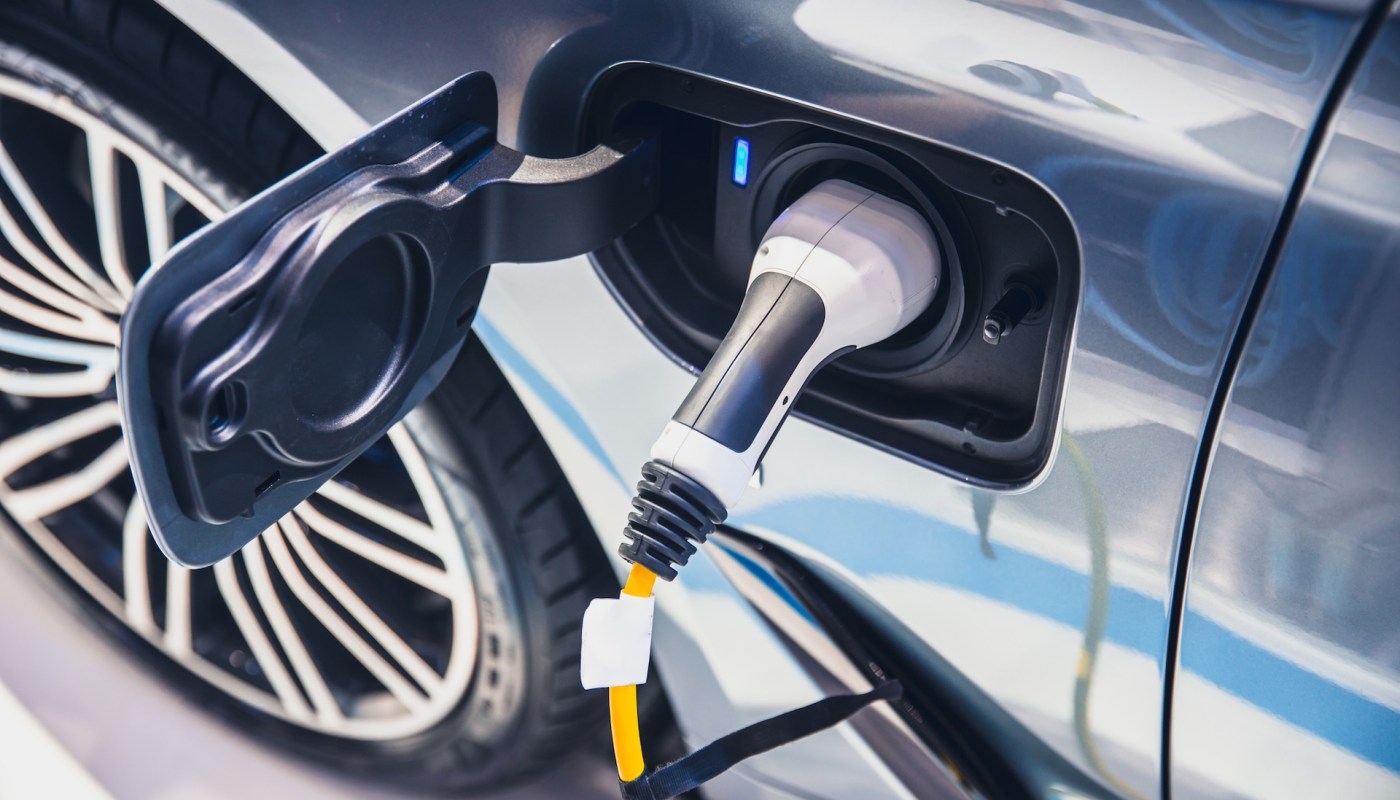 An electric vehicle plugged into the charging port.