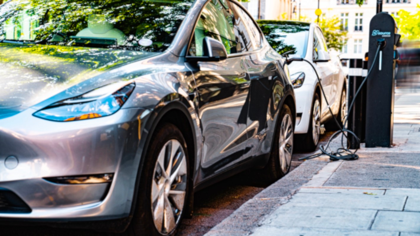 An electric car at a curbside charging station.