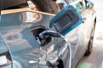 An electric vehicle plugged into a charger.