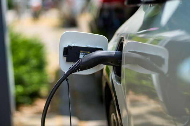 An EV charger plugged into a car.
