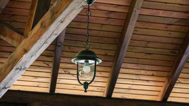 A lightbulb hanging from a ceiling.