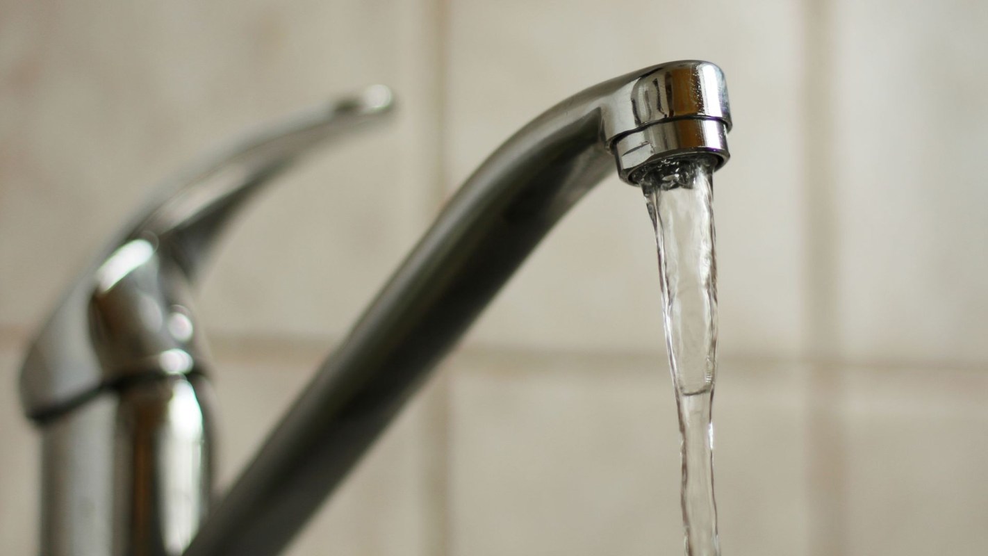 Water running out of a faucet.
