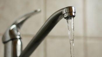 Water running out of a faucet.