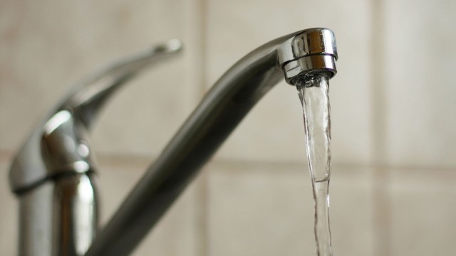 Water running out of a faucet.