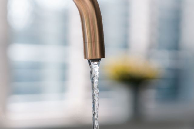 Tap water running out of a faucet.