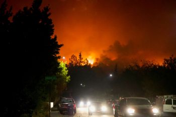 Cars driving away from a wildfire.
