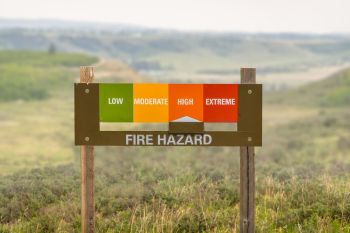 A sign indicating there is a "high" fire hazard.