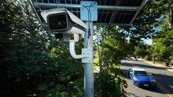 A security camera near a road.