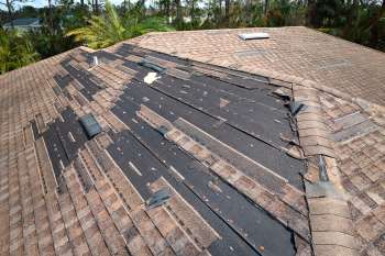 A roof with missing shingles.