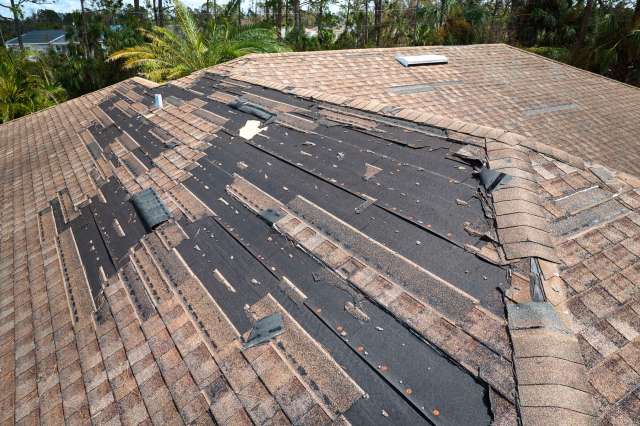 A roof with missing shingles.