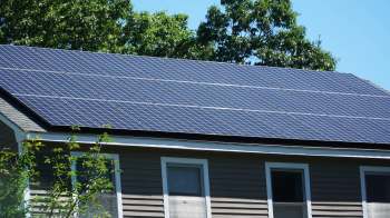 A house with solar panels installed on the roof.