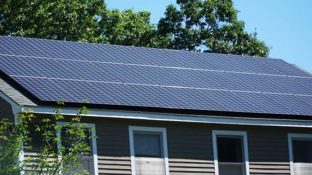 A house with solar panels installed on the roof.