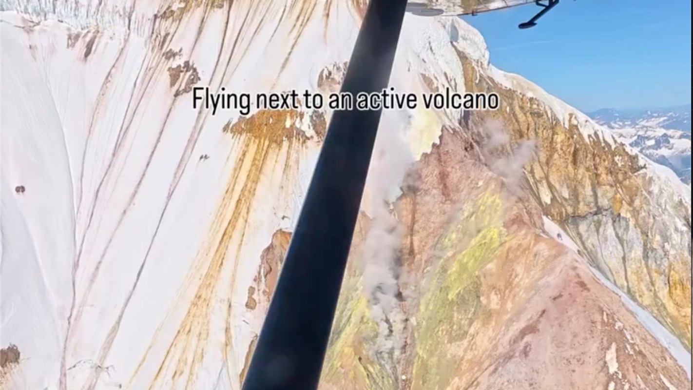 An airplane flying next to an active volcano.