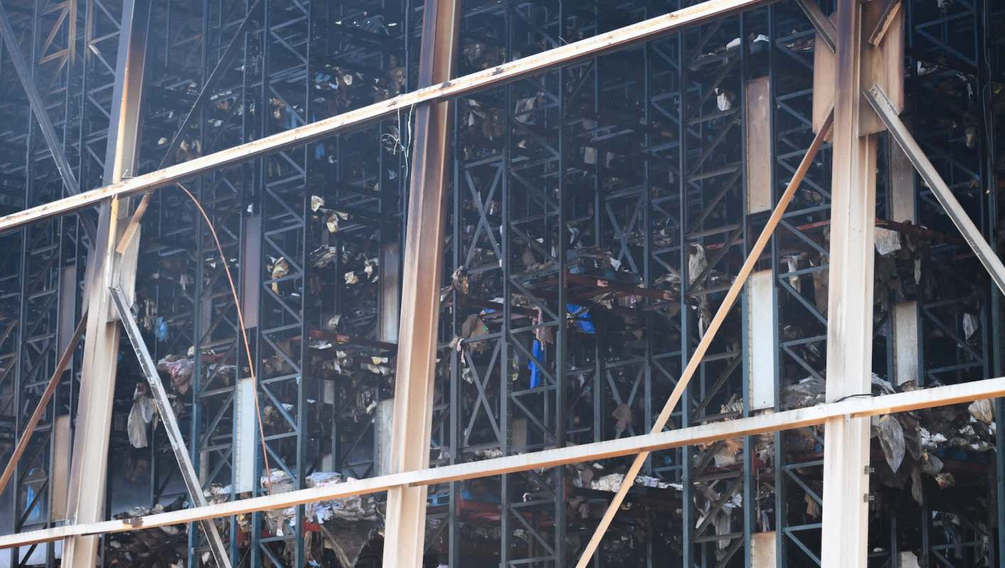 A view of a large metal structure with burned and damaged materials inside.