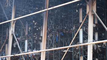A view of a large metal structure with burned and damaged materials inside.