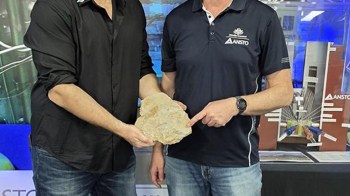Researchers holding a fossil.