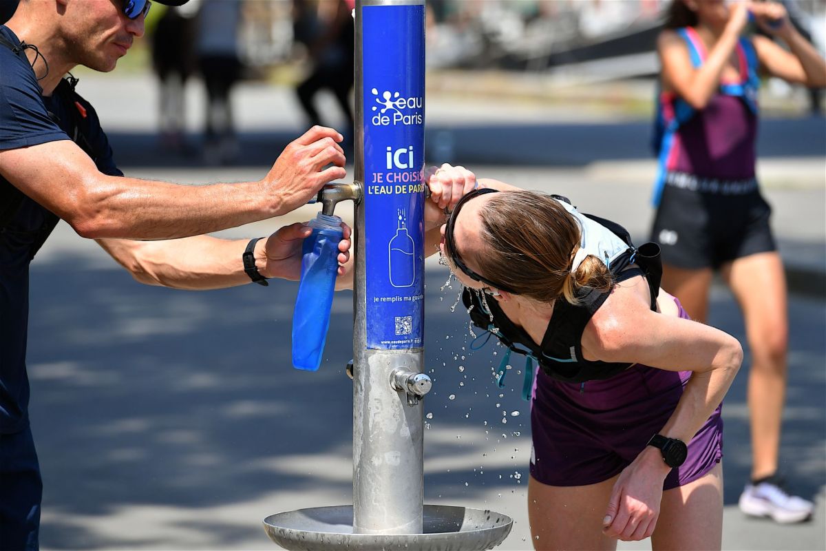 People using a public fountain.
