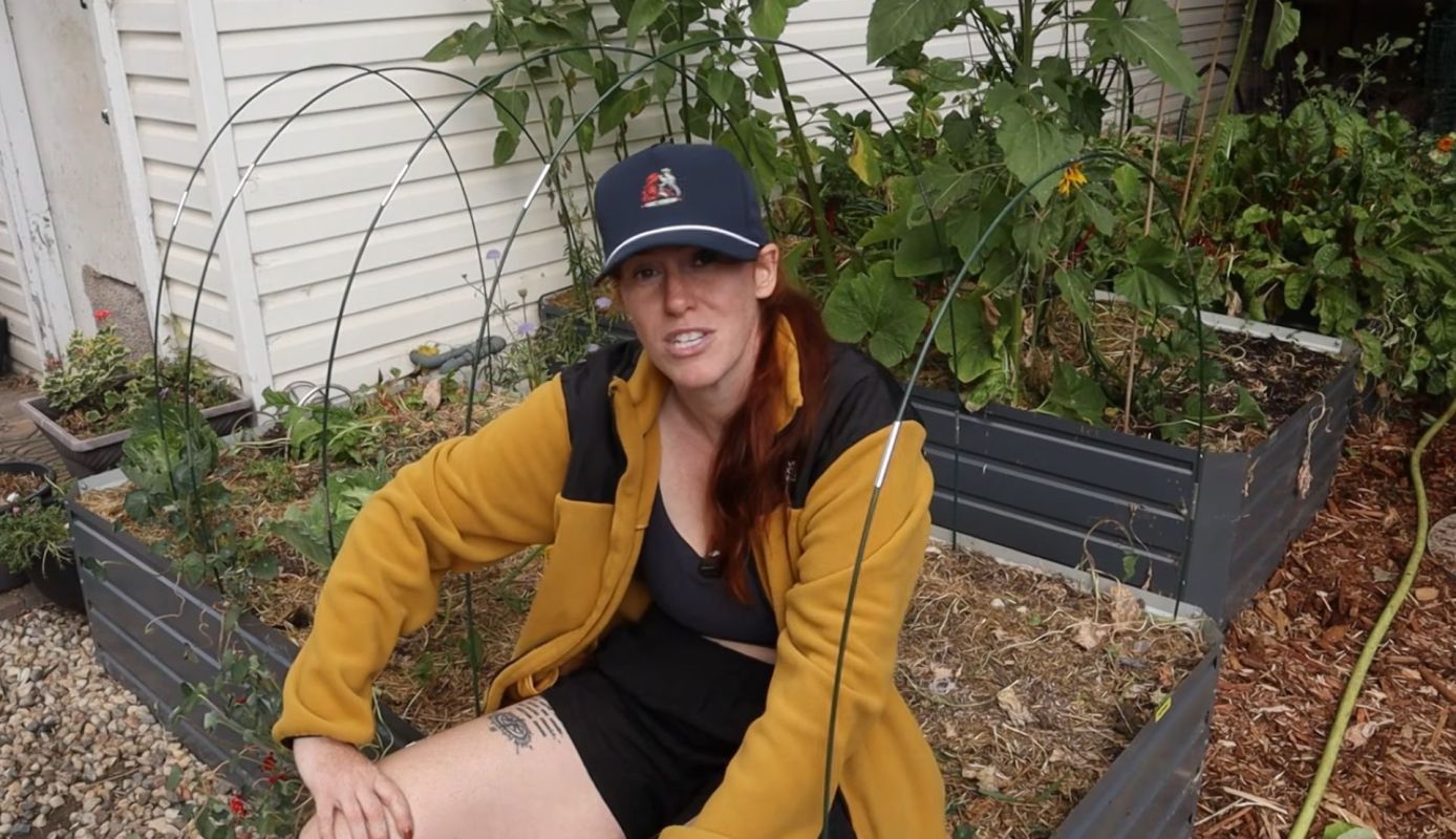A woman sitting in a garden.