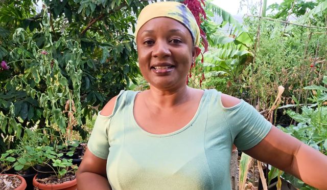 A woman standing in a garden.