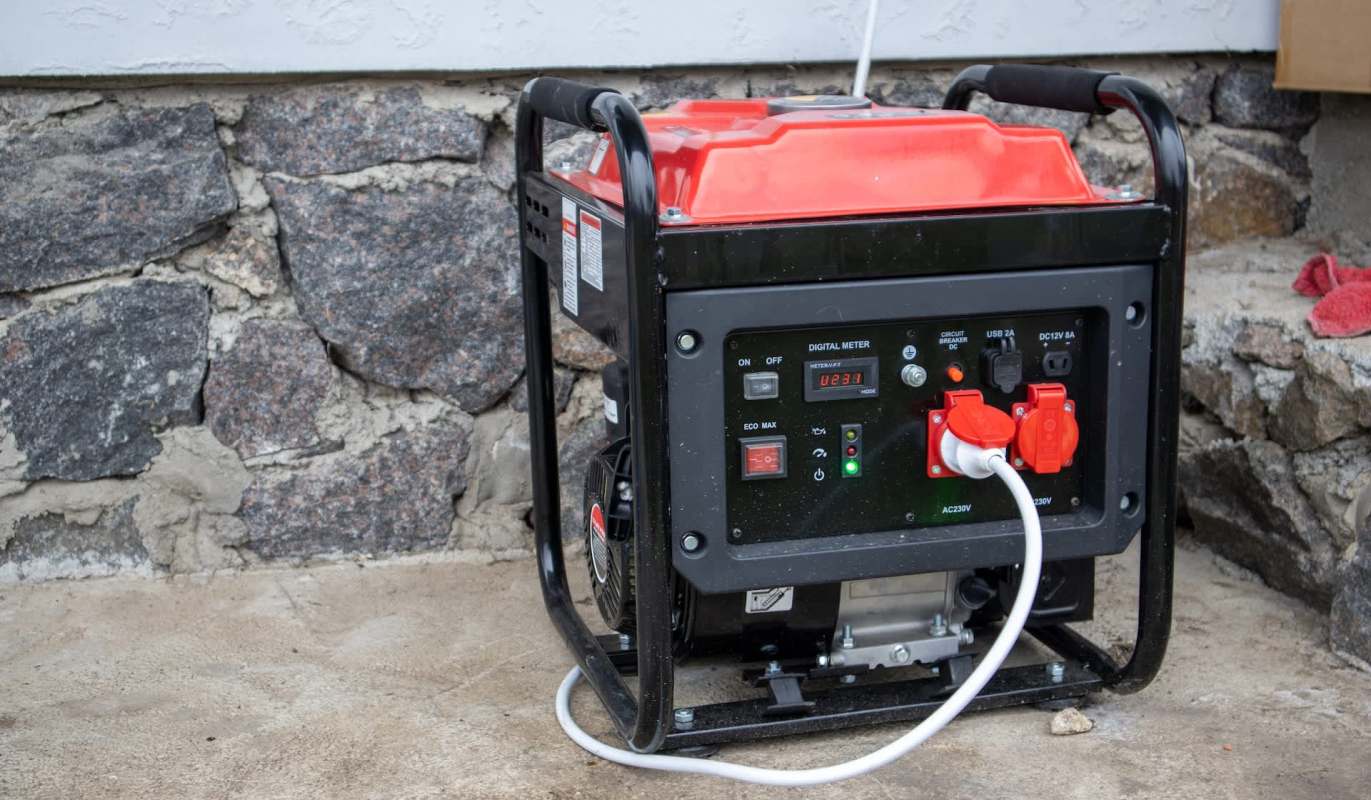 A portable generator with a digital meter and multiple power outlets.
