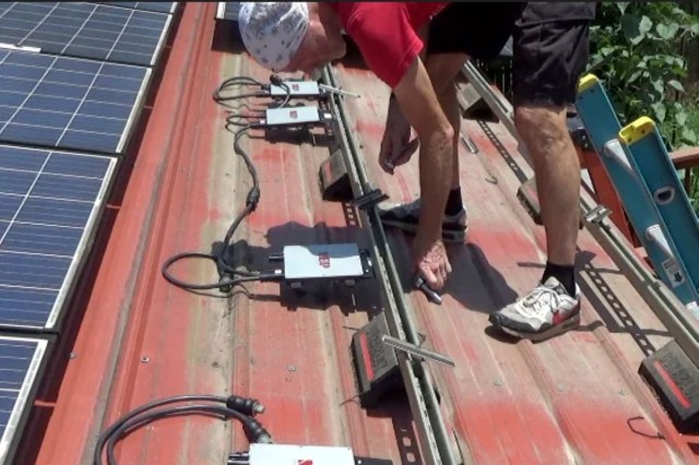 A person installing NEP inverters.
