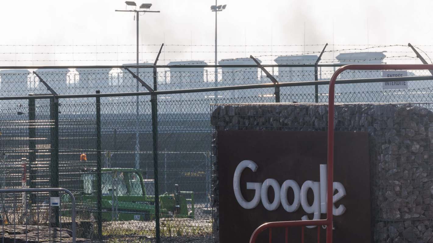 A Google sign in front of a fenced area.