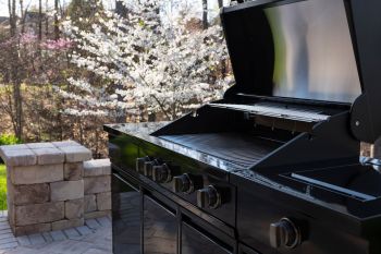 A grill with an open lid.
