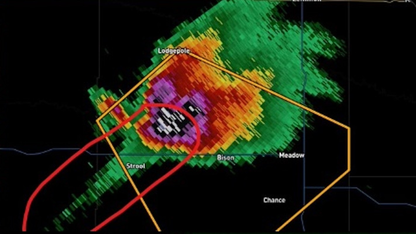 A weather radar image showing a storm cell with indicated areas of intense precipitation and a tornado warning.
