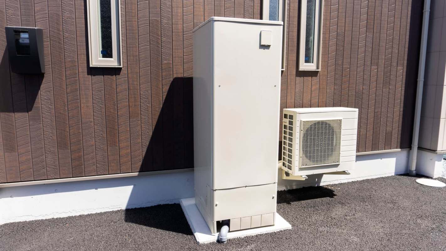 A white utility box and an air conditioning unit mounted on a brown wooden wall.