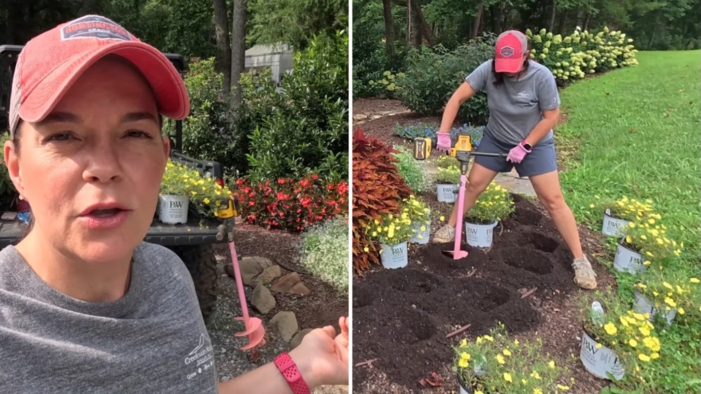 A woman uses a drill to dig in a garden surrounded by flowers and potted plants.