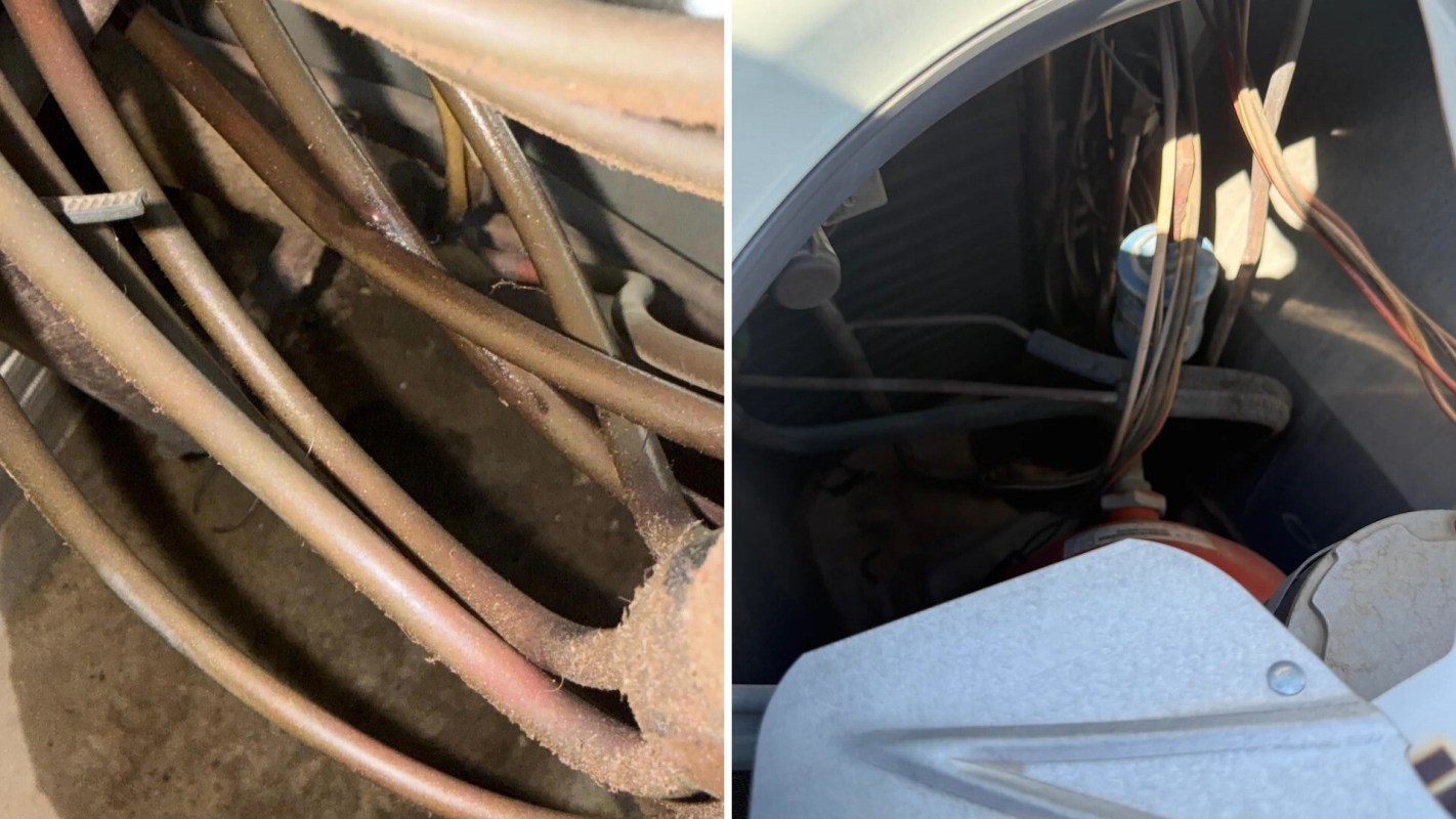 Various tangled wires and pipes inside a mechanical unit.