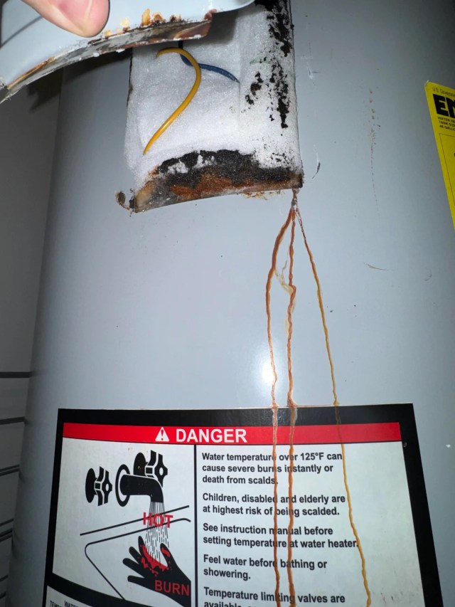 Rust-colored streaks on a water heater.