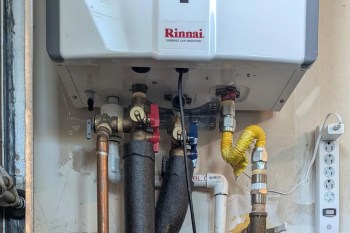 Pumps and valves coming out of a tankless water heater.
