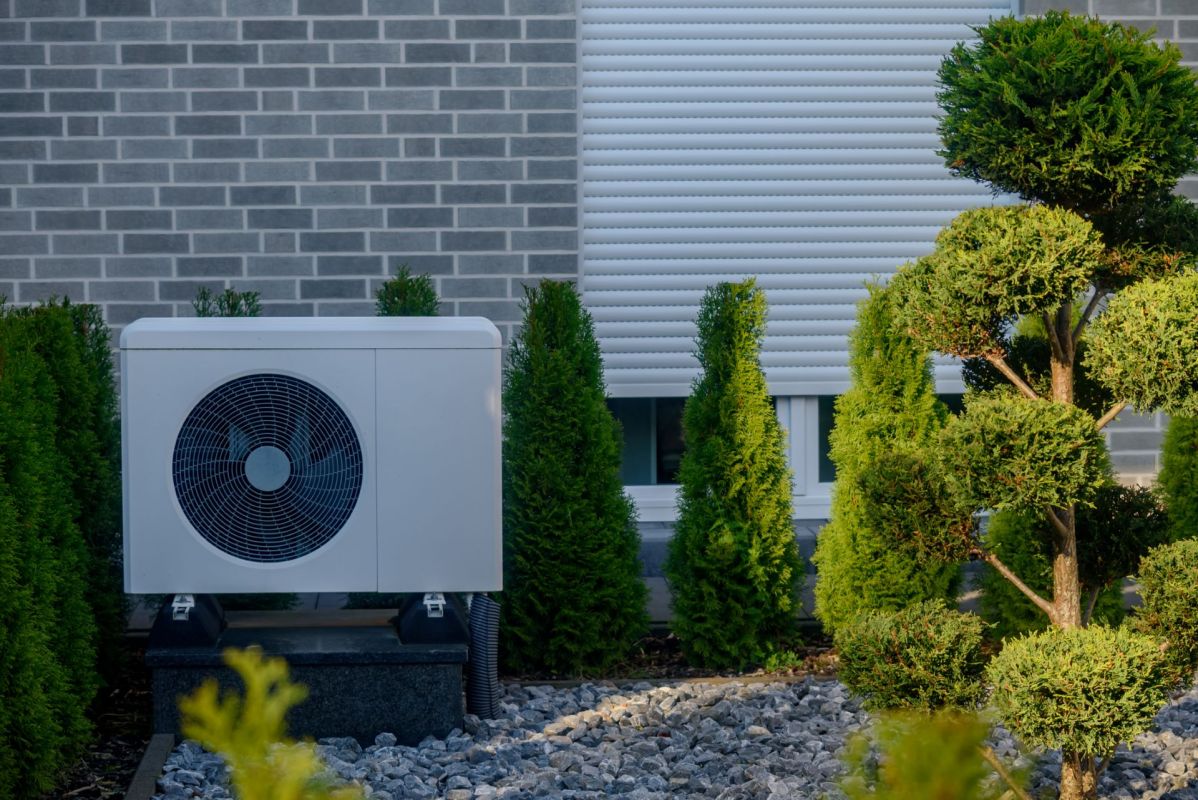 A heat pump unit outside a house.